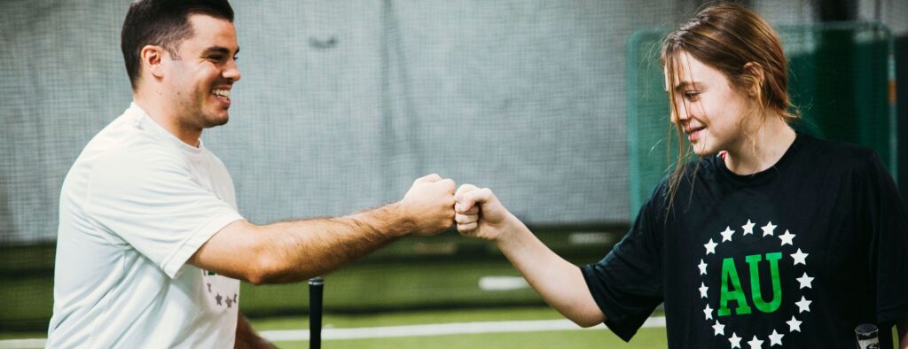 Private mental performance coach celebrating with an athlete during lesson